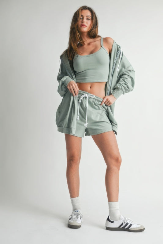 Woman wearing the Sweater 3 Piece Set in soft fabric, featuring a cozy top, matching bottoms, and a layering hoodie.