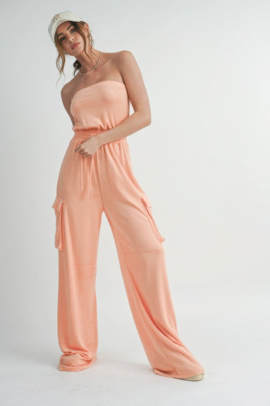 Tube top jumpsuit romper in peach color, relaxed fit, casual summer fashion.
