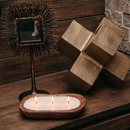 3-wick dough bowl soy candle on wooden surface with decorative items.