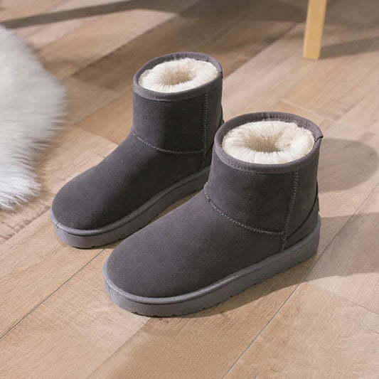Winter Women Snow Boots on wooden floor, featuring cozy fur lining and sleek dark finish.